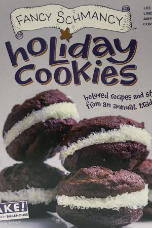 Colorful purple book cover with chocolate sandwich cookies and icing sugar