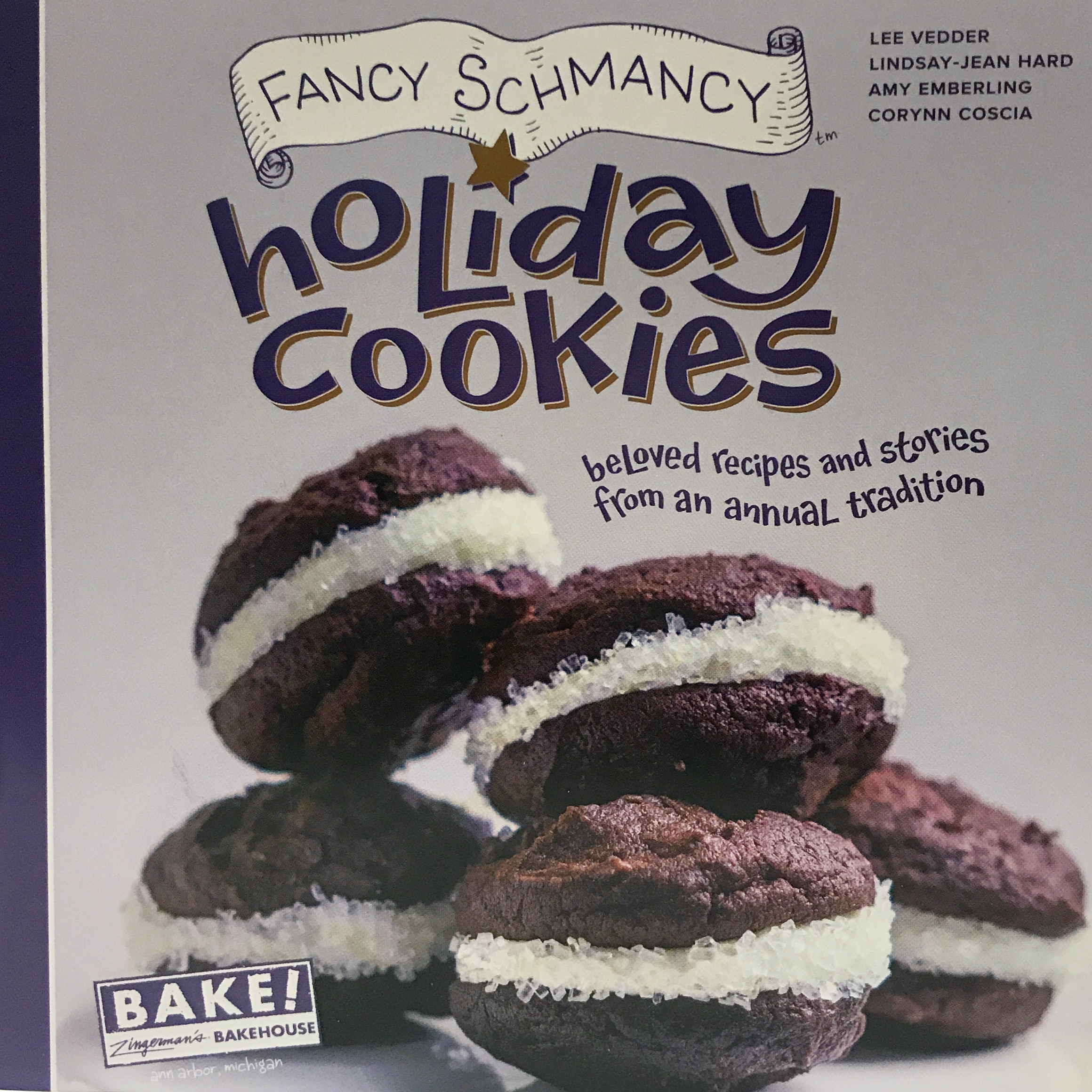 Colorful purple book cover with chocolate sandwich cookies and icing sugar